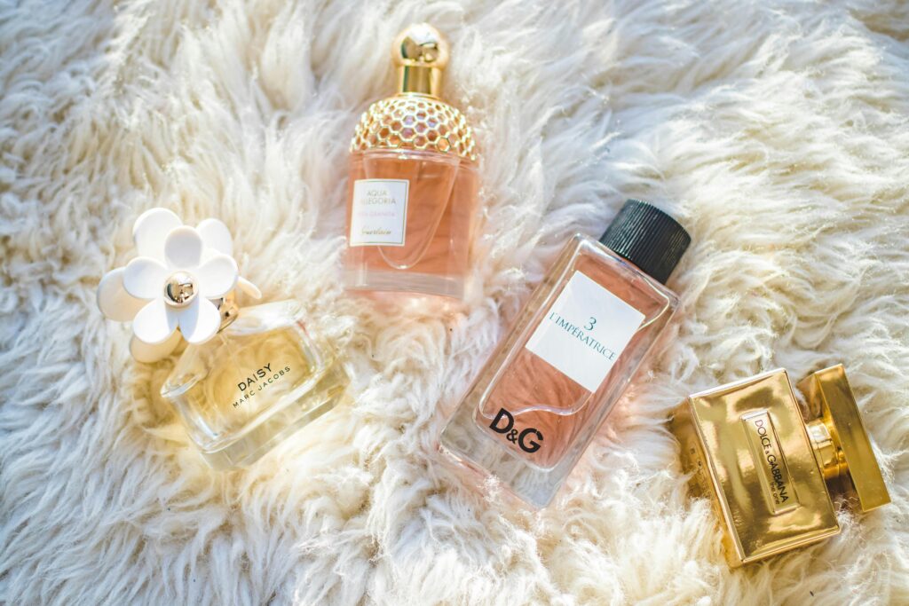 pexels-photo-965989-965989 Elegant collection of perfume bottles on soft fur, highlighting luxury and style.