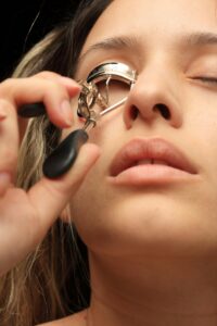 pexels-photo-1435821-1435821 A close-up shot of a woman curling her eyelashes with a manual curler.