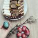 A high-angle shot of Easter pastries and beautifully decorated eggs on a wooden table, perfect for holiday inspirations.