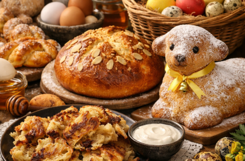 Velikonoční stůl s tradičními českými pokrmy – mazanec, jidáše s medem, piškotový beránek, škaredý bramborák, barevná vejce a jarní květiny na rustikálním dřevěném stole